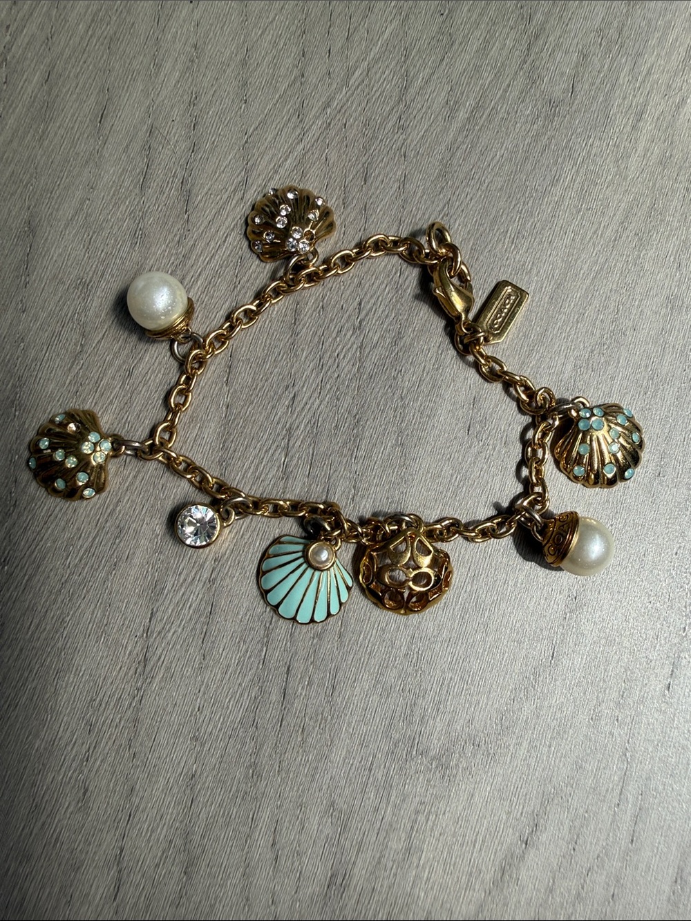 COACH- Gold-Tone Charm Bracelet with Turquoise Enamel Shells and Pearls